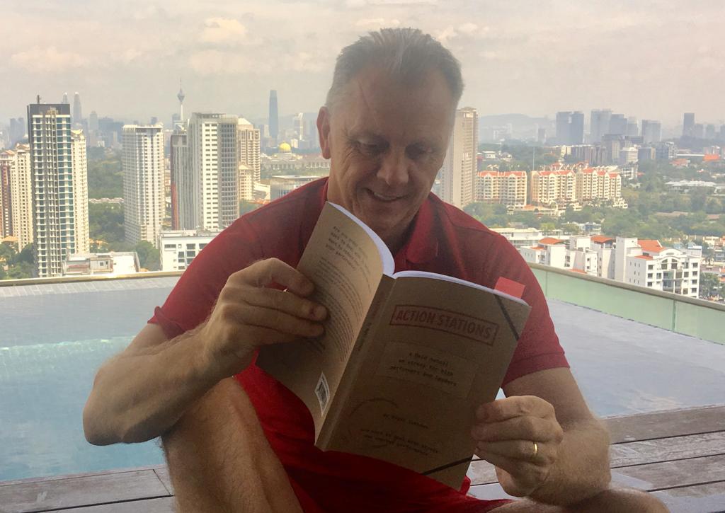 Olympic Sports Performance Specialist Tim Newnham, reading a copy in Kuala Lumpur. Olympic Sports Performance Specialist Tim Newnham, reading a copy in Kuala Lumpur.